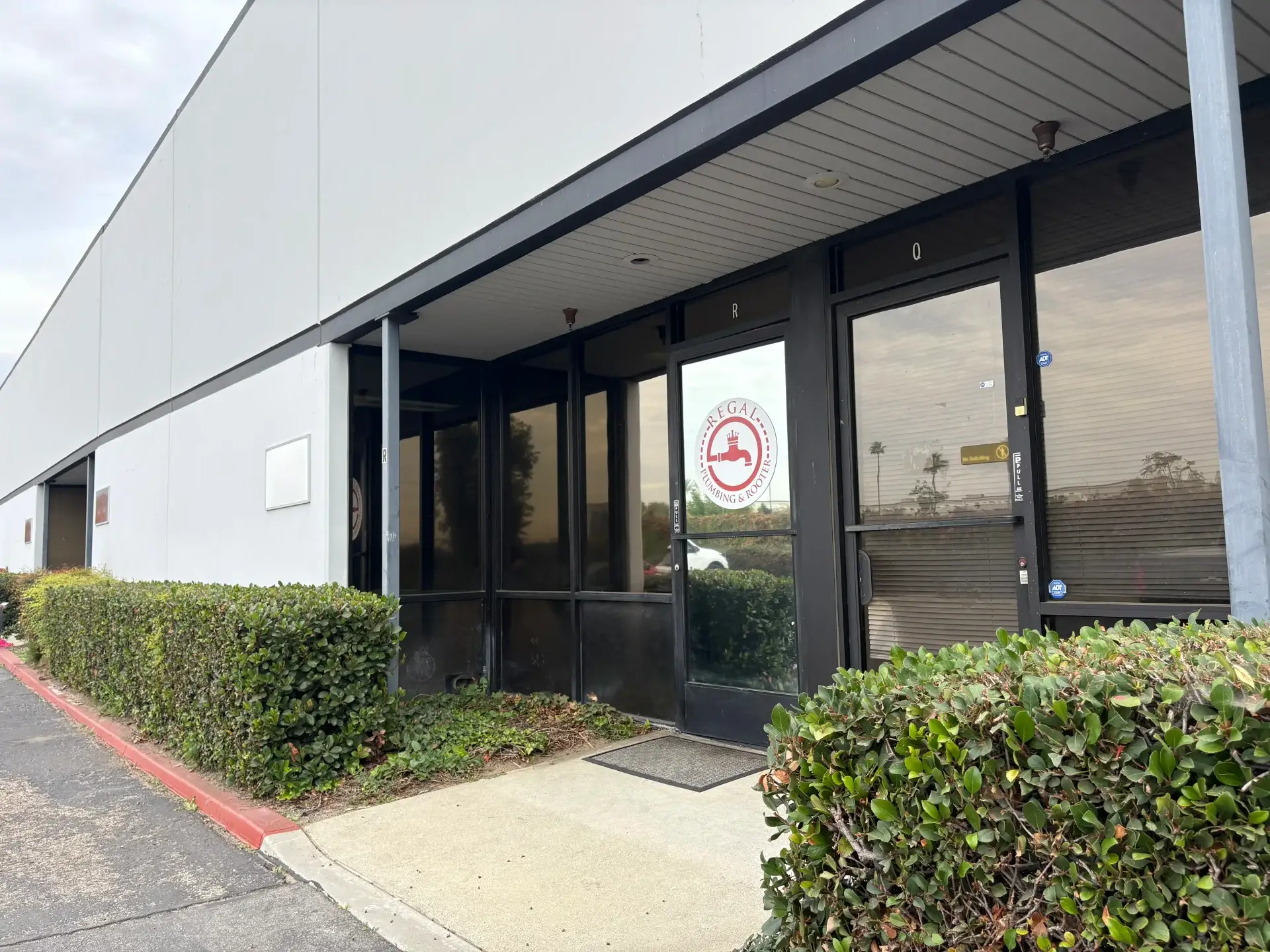 Regal Plumbing & Rooter office entrance in Ontario, CA featuring company logo and modern architecture